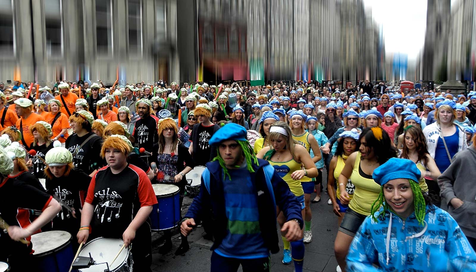 Photo of people playing drums and dancing in the street
